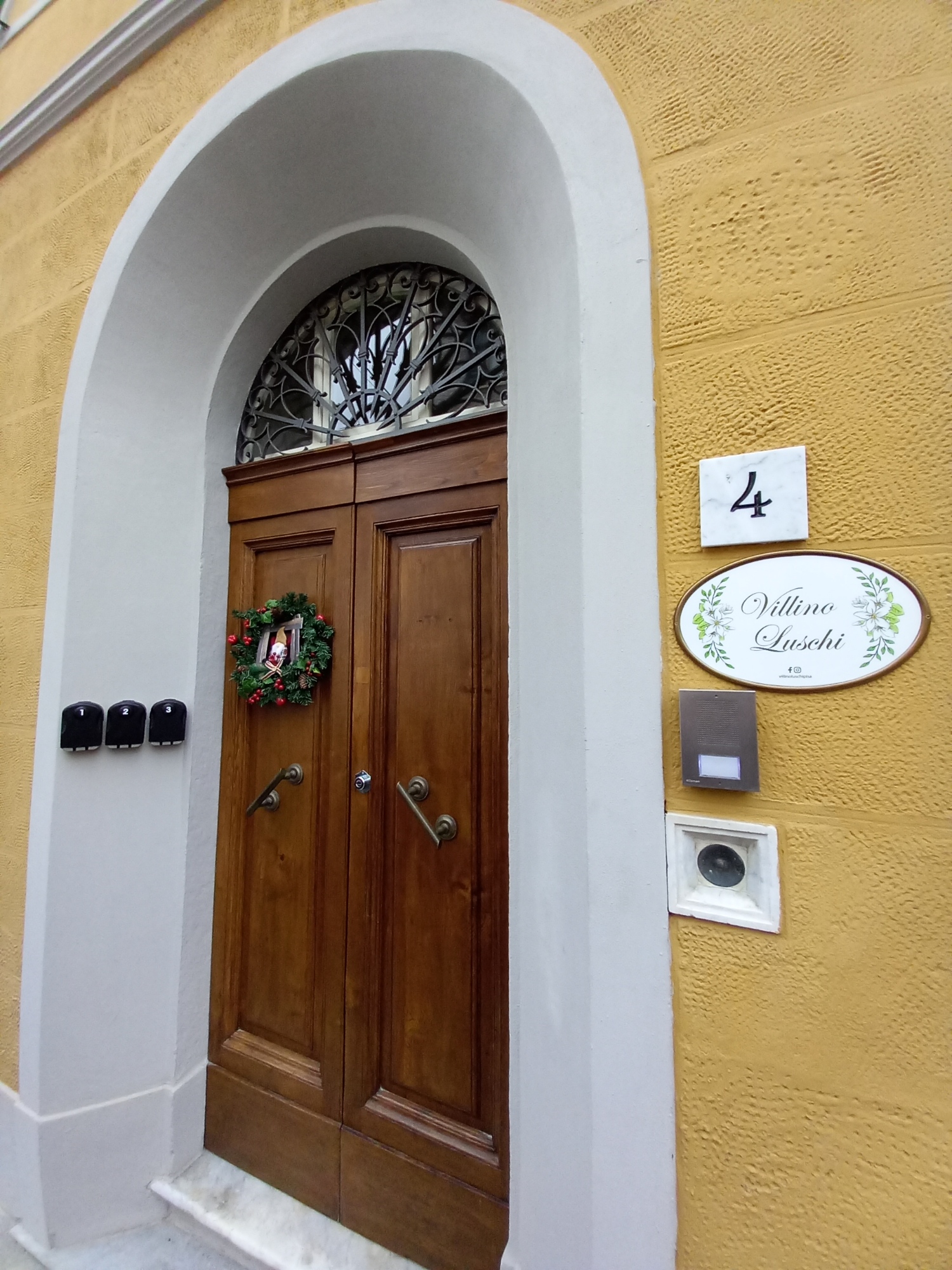 Historic front door and sign of the Villino Luschi B&B, a residence dating from the early 20th century