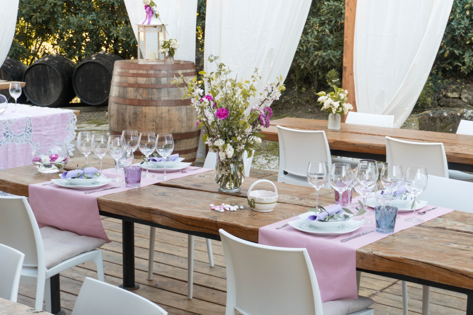 A detail of the outdoor space of the agriturismo dedicated to the tasting area with outdoor tables, tents and comfortable chairs
