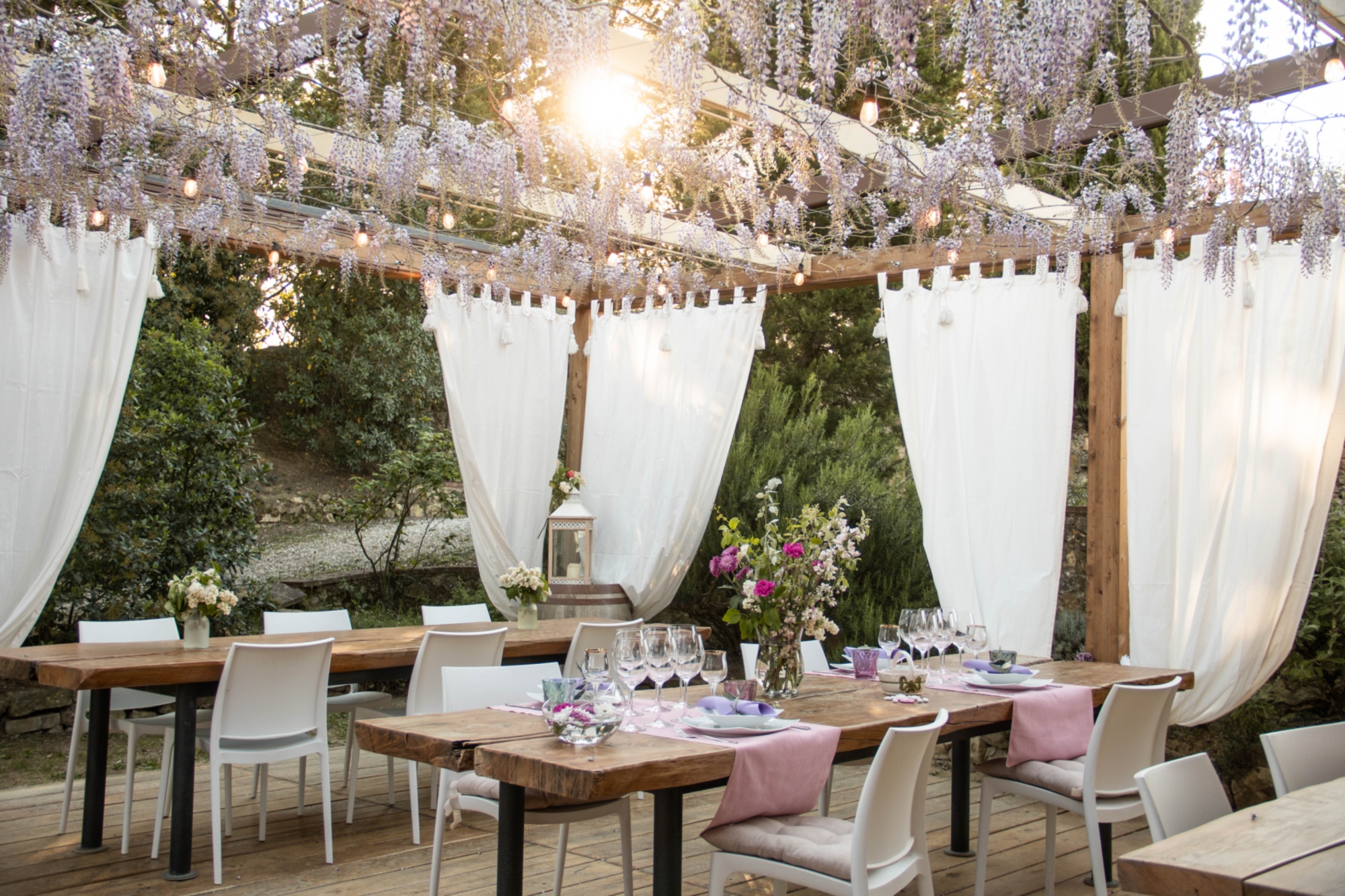 The outdoor space of the agriturismo dedicated to the tasting area with outdoor tables, tents and comfortable chairs