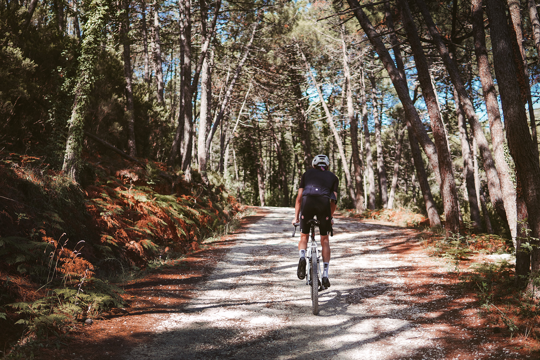 riding along a gravel segment in Tuscany