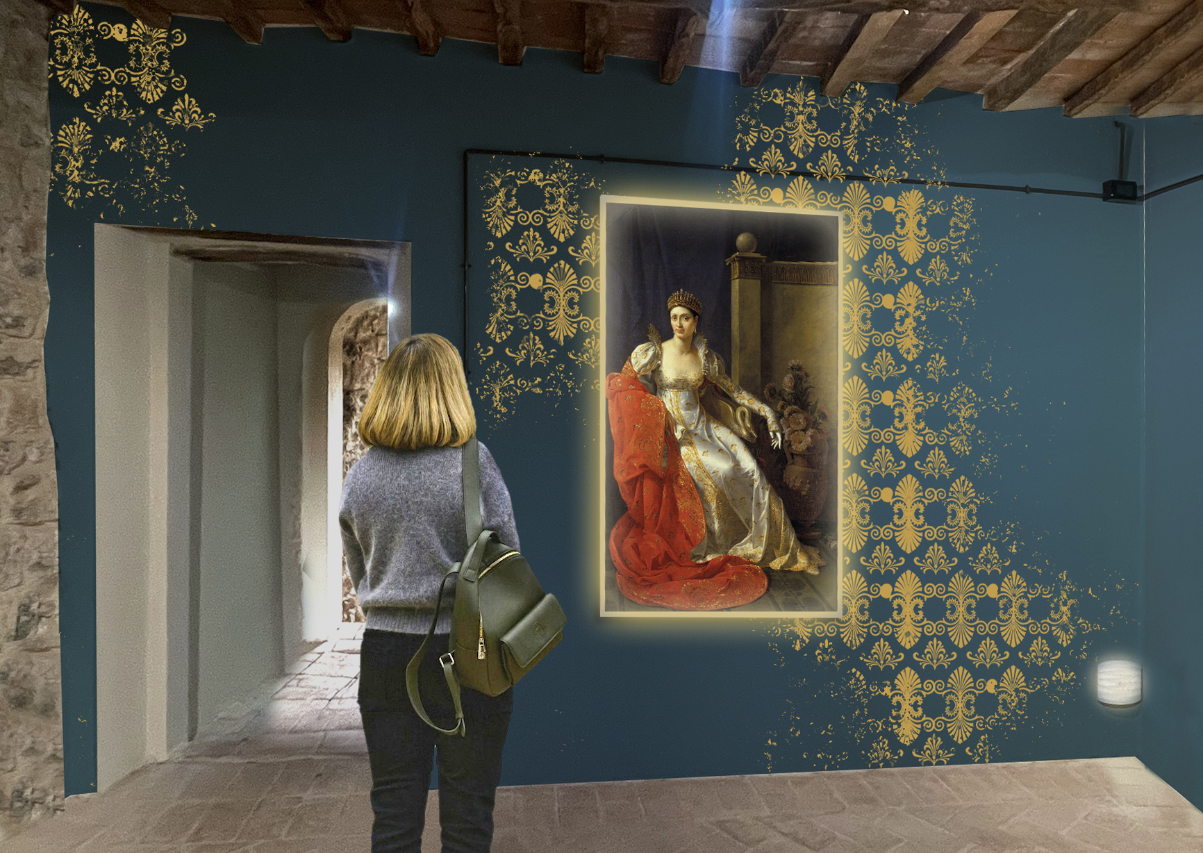 Una persona guarda un quadeo nelle sale del Museo della Rocca Aldobrandesca