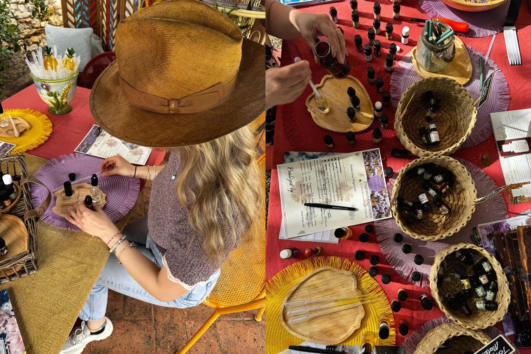 Donna con cappello miscela oli essenziali su un tagliere in legno, accanto a un tavolo con boccette di essenze, cestini e schede per comporre il proprio profumo