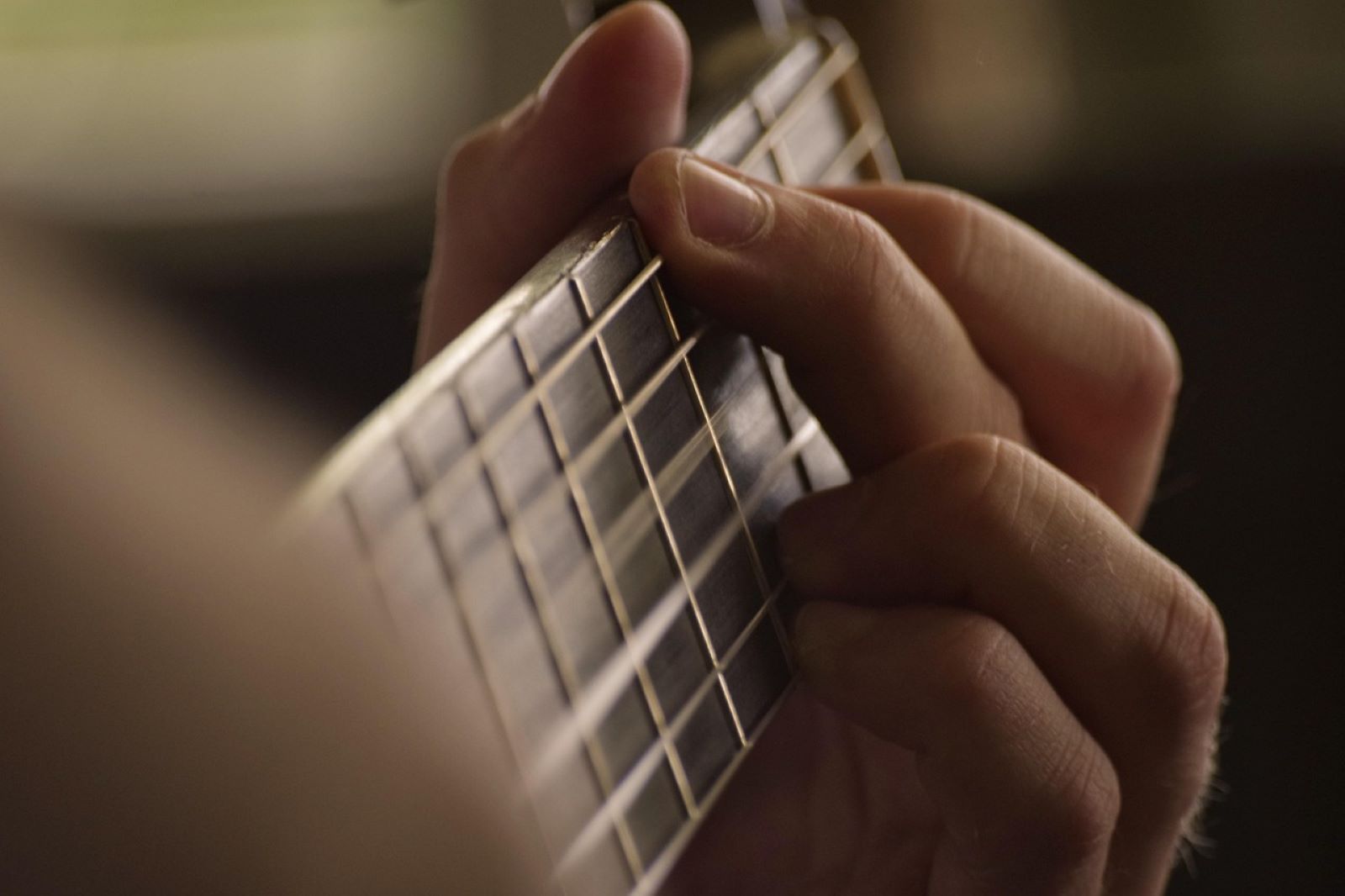 mano che suona una chitarra