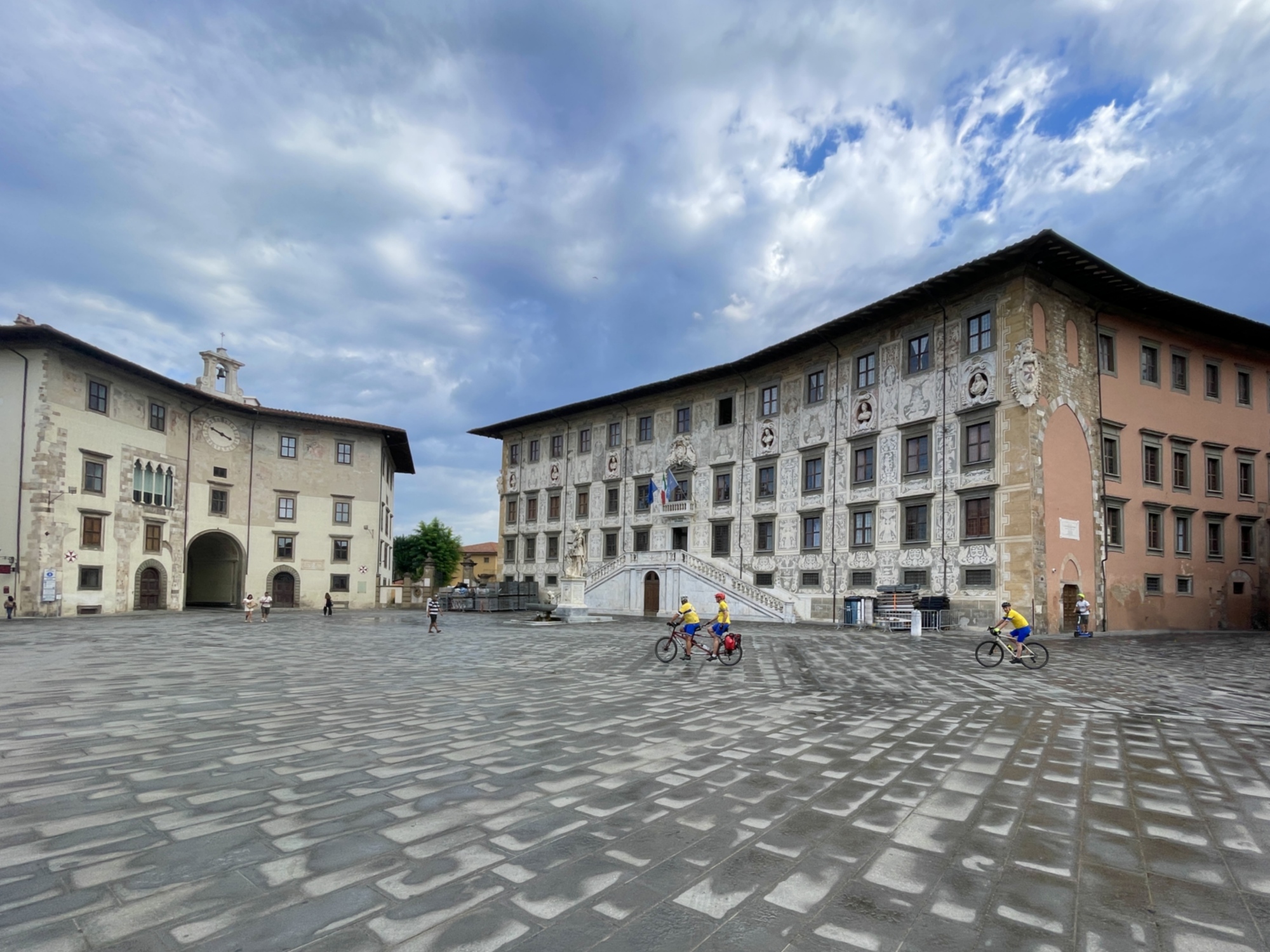 View of the Piazza dei Cavalieri in Pisa as some cyclists pass by