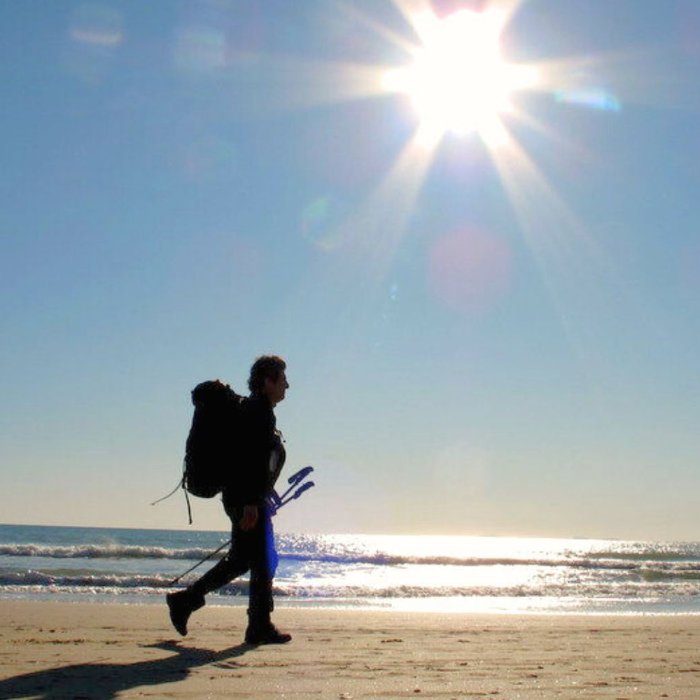 man-walking-on-the-beach-in-camaiore