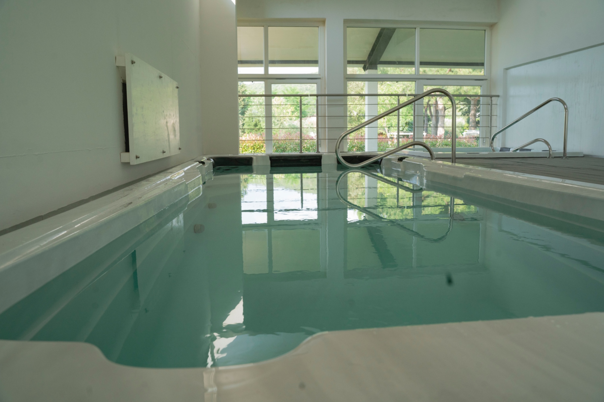 Heated indoor swimming pool and hot tub in the wellness area