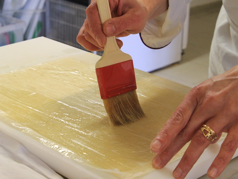 <br />Overlay three sheets of phyllo dough, brushing melted butter between the sheets.