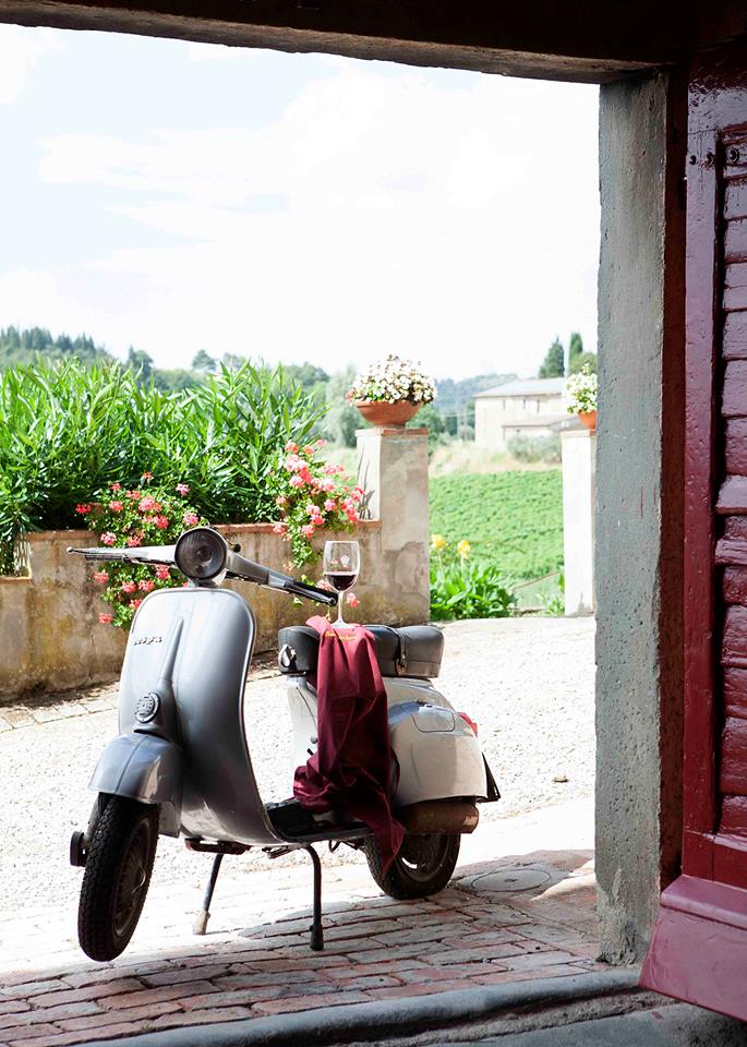 The Vespa, an icon of Tuscany, and a glass of wine The Vespa, an icon of Tuscany, and a glass of wine
