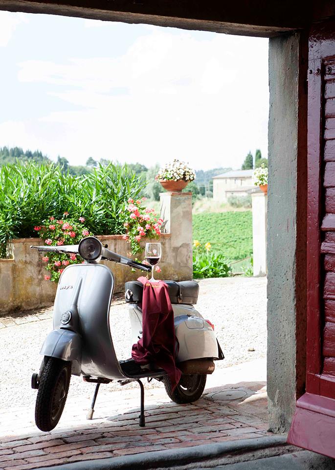 The Vespa, an icon of Tuscany, and a glass of wine