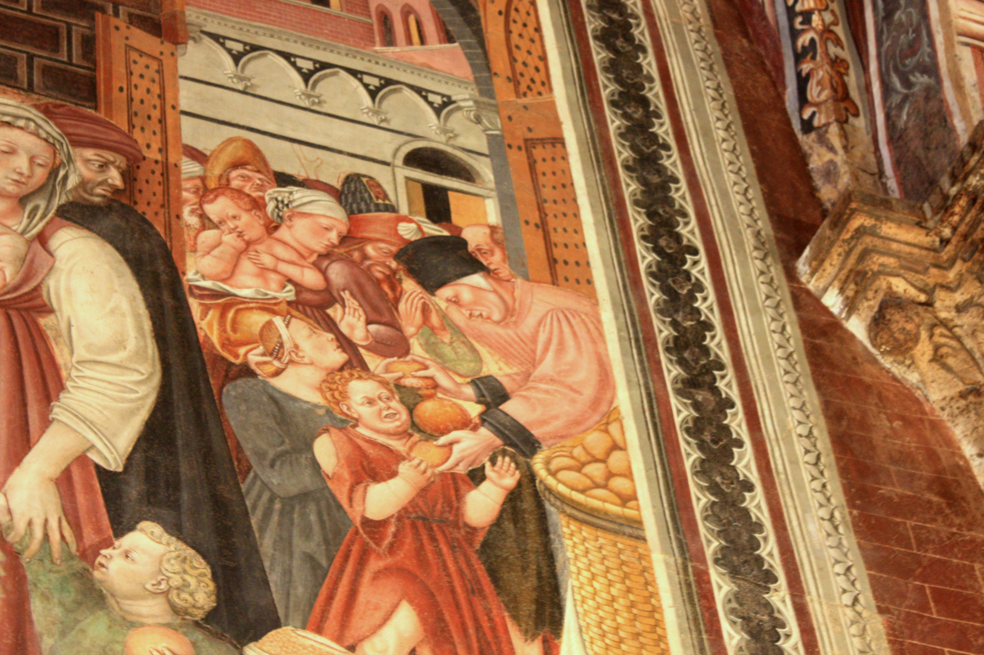 La distribuzione del pane ai poveri dipinta nella Sala del Pellegrinaio